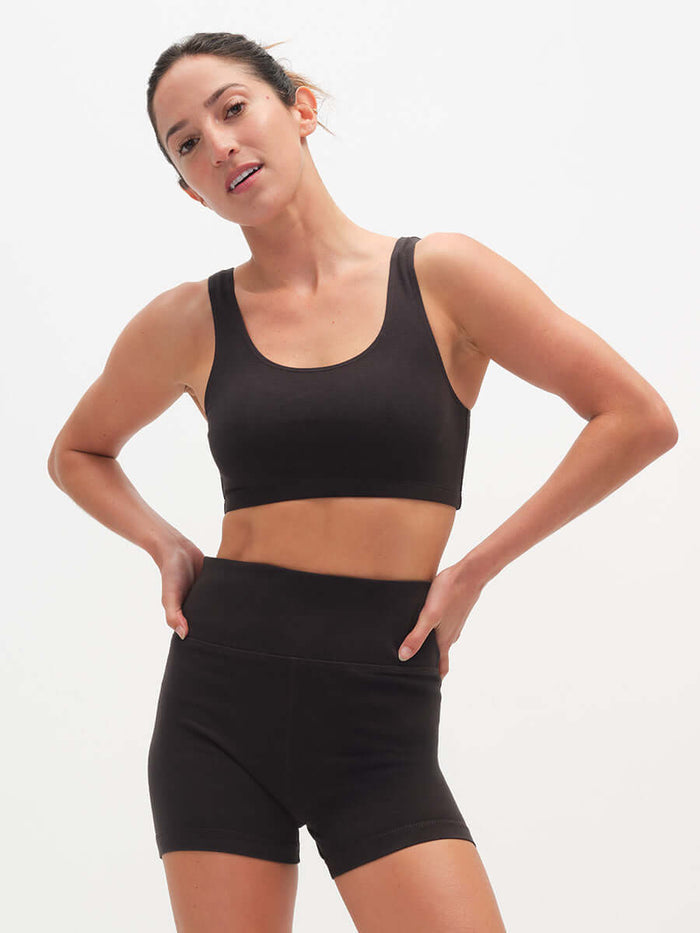 Model wearing Echo 3.5" Short in Black with tall waistband and supportive stretch, styled for activewear.